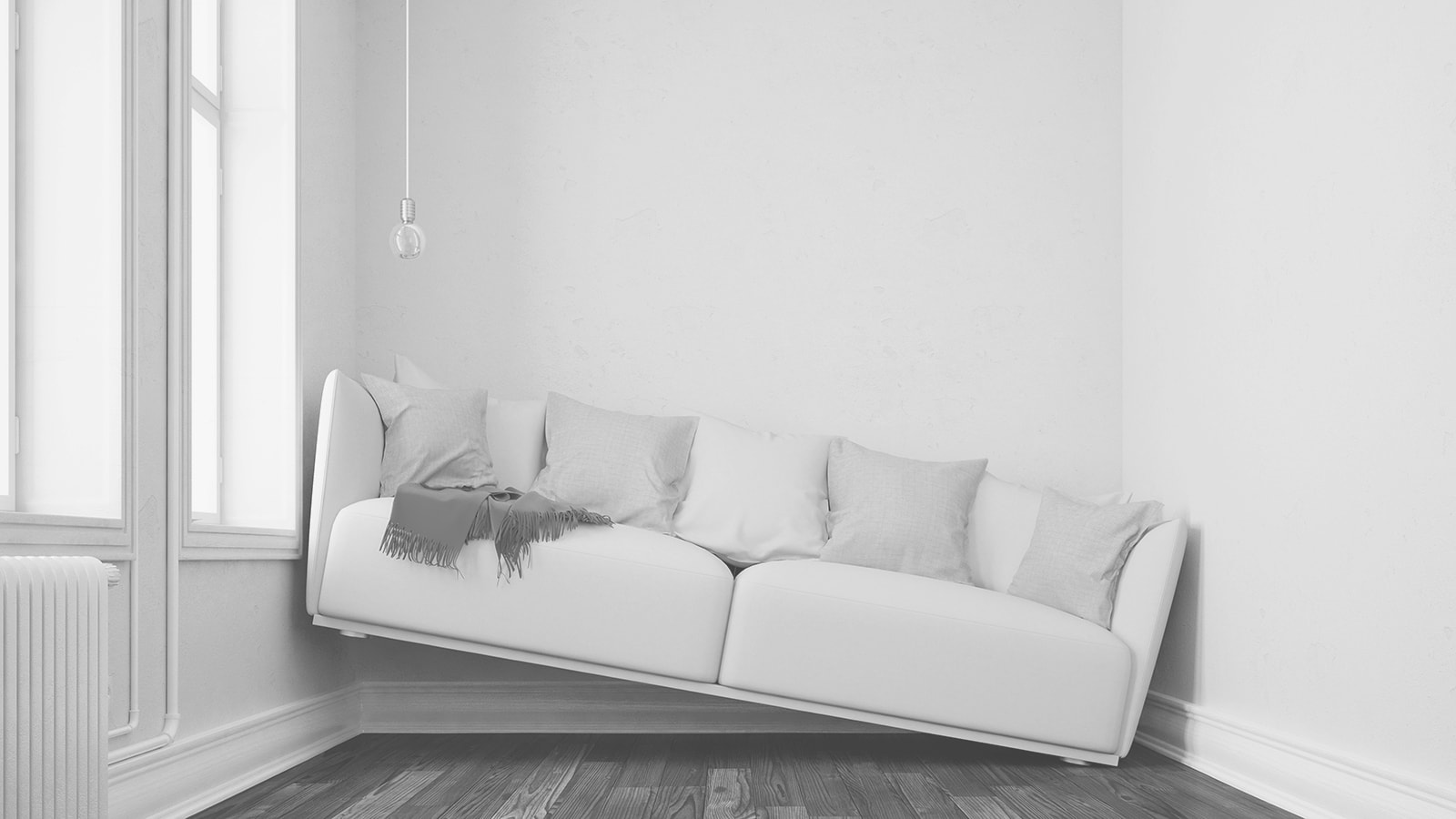 En stor sofa står på skrå mellem to vægge